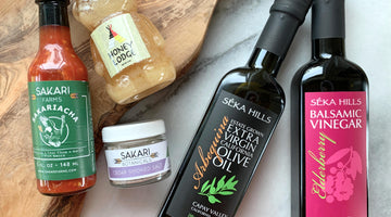 The ingredients for the Sweet and Spicy Salad Dressing, including Olive Oil and Balsamic Vinegar from Séka Hills, Sakariacha hot sauce and Cedar Smoked Salt from Sakari Farms and Honey from Honey Lodge.