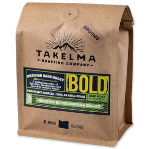A 12 oz, light brown bag of ground, dark roast coffee from Takelma Roasting Co.