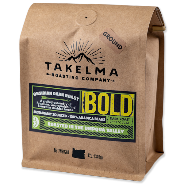 A 12 oz, light brown bag of ground, dark roast coffee from Takelma Roasting Co.