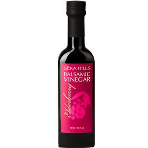 A dark glass bottle of Elderberry Balsamic Vinegar from Séka Hills on a white background.