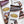 Load image into Gallery viewer, Three wrapped chocolate bars (milk, dark and milk with almonds) are laying flat on a marble background.
