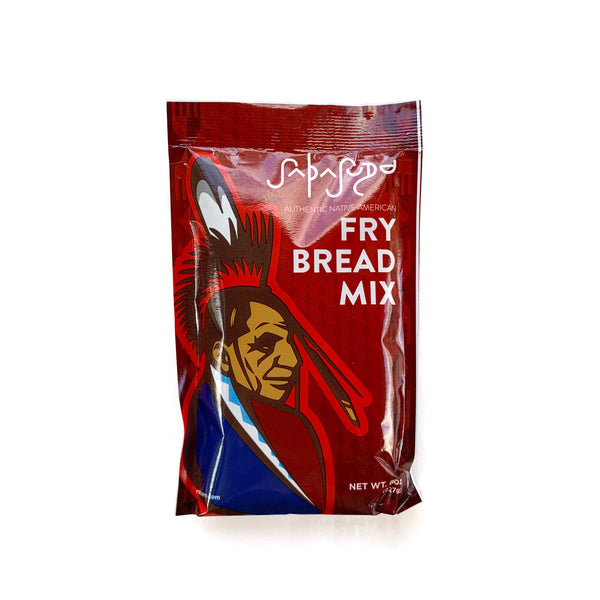 Small package of fry bread mix on white background.